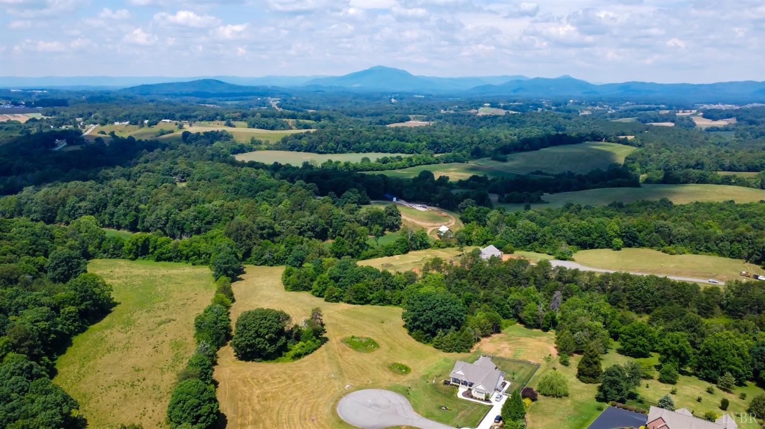 an aerial view of a house with yard