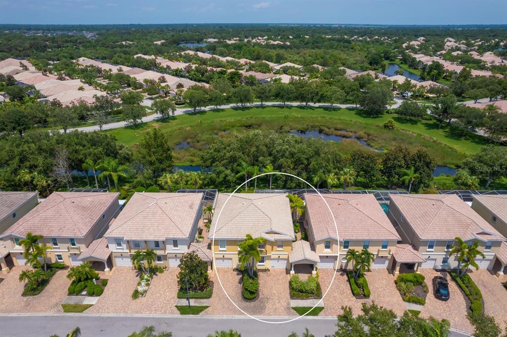 an aerial view of residential houses with outdoor space and river