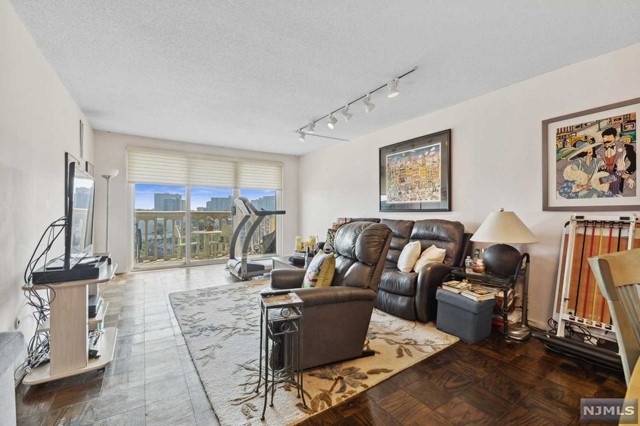 a living room with furniture and a floor to ceiling window