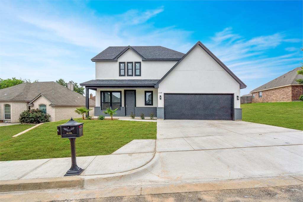 a front view of a house with yard