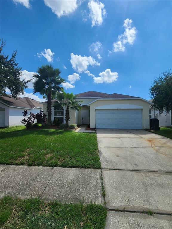 a front view of a house with a yard and a garage