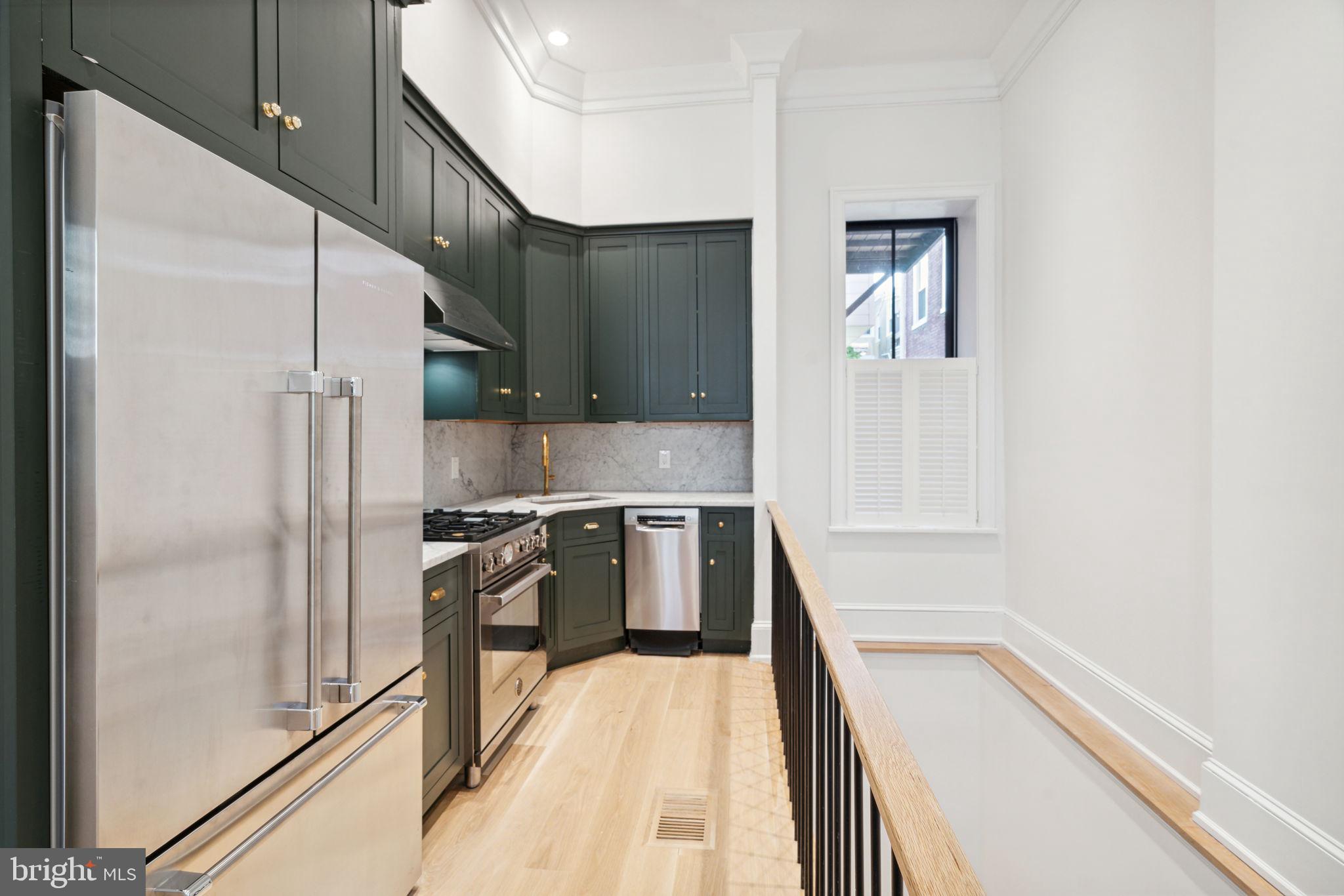 a kitchen with a refrigerator and a sink