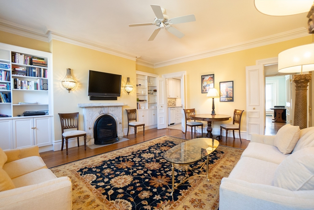 a living room with furniture a fireplace and a flat screen tv