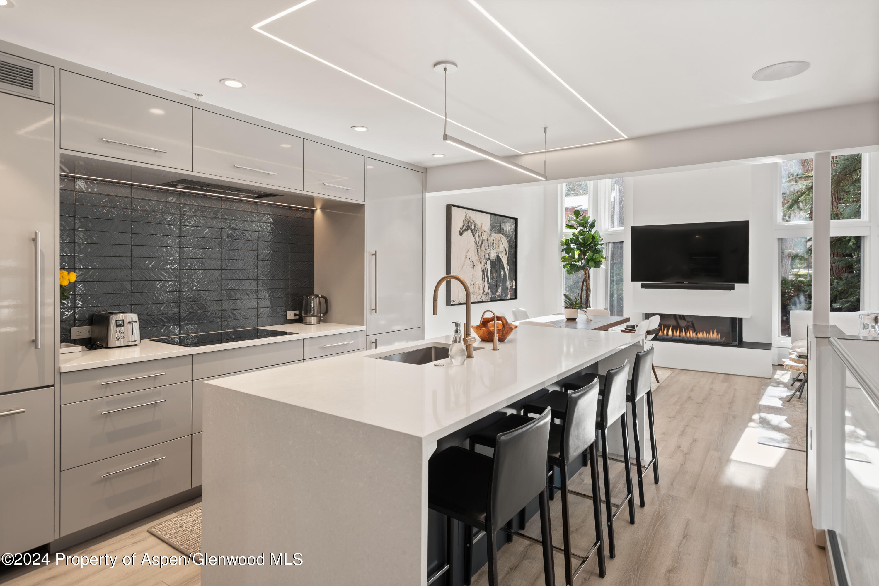 a large kitchen with a table and chairs