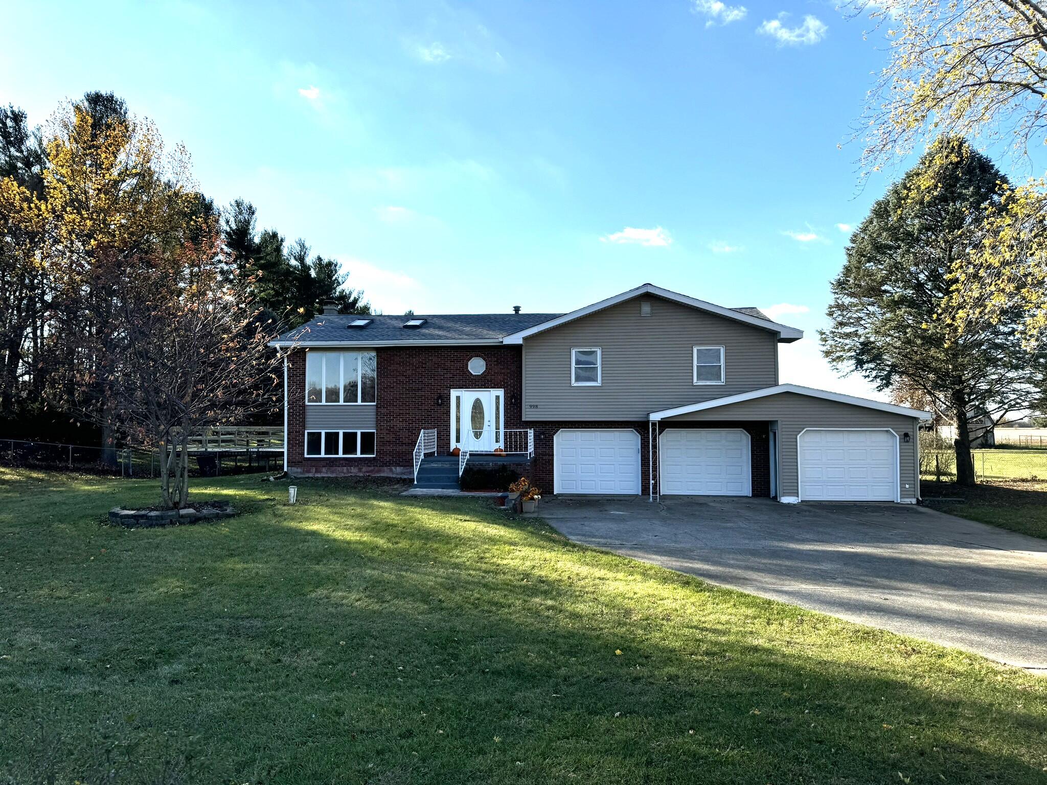 a view of a house with a yard and sitting area