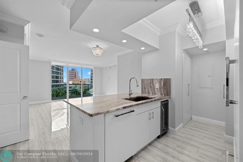 a kitchen with stainless steel appliances granite countertop a sink and a refrigerator