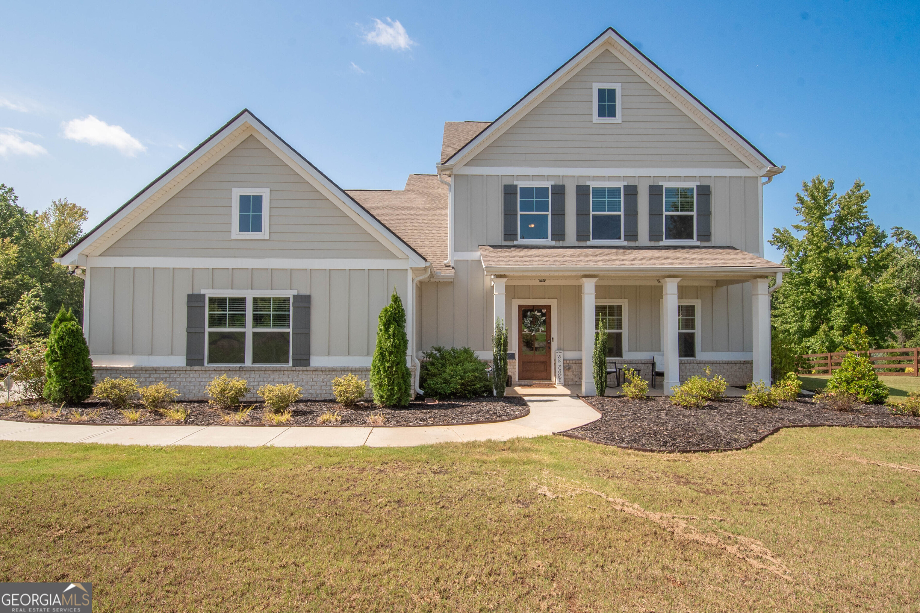 a front view of a house with a yard