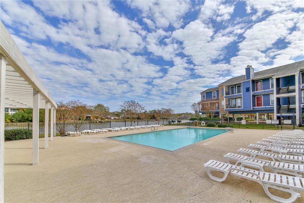 a view of a swimming pool and lounge chairs