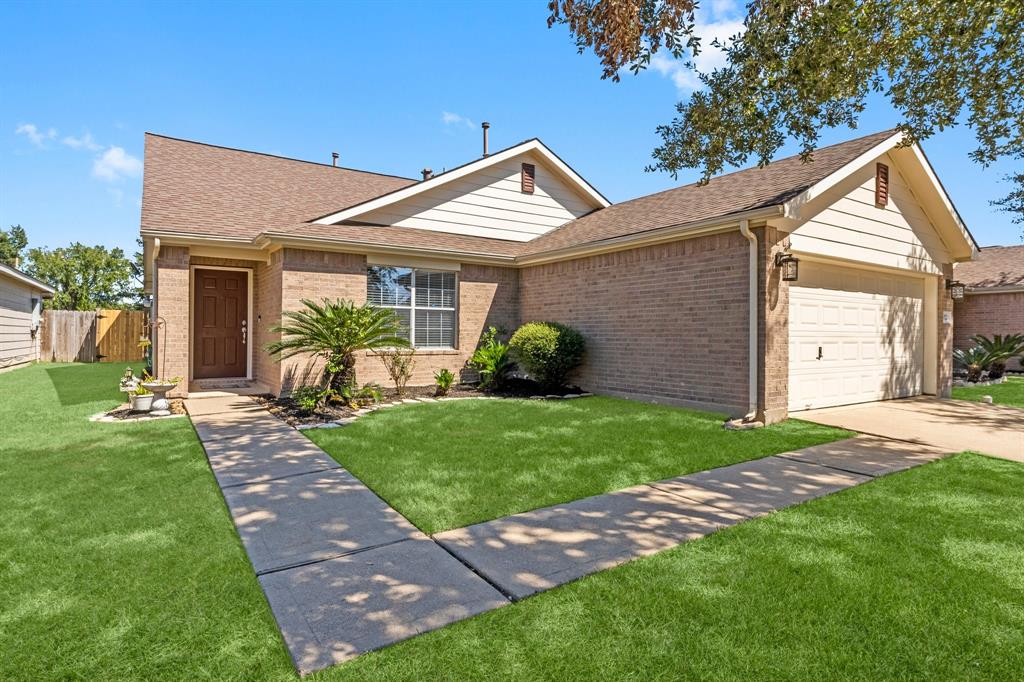 a view of a house with a yard and plants