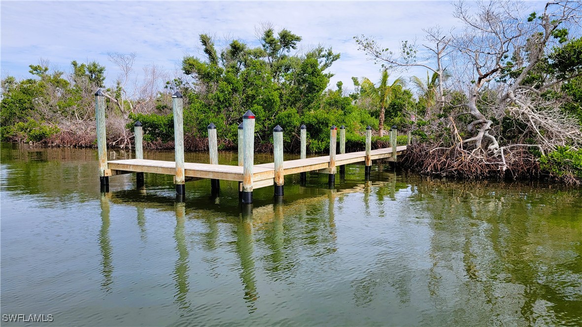 a view of residential house with yard and lake view