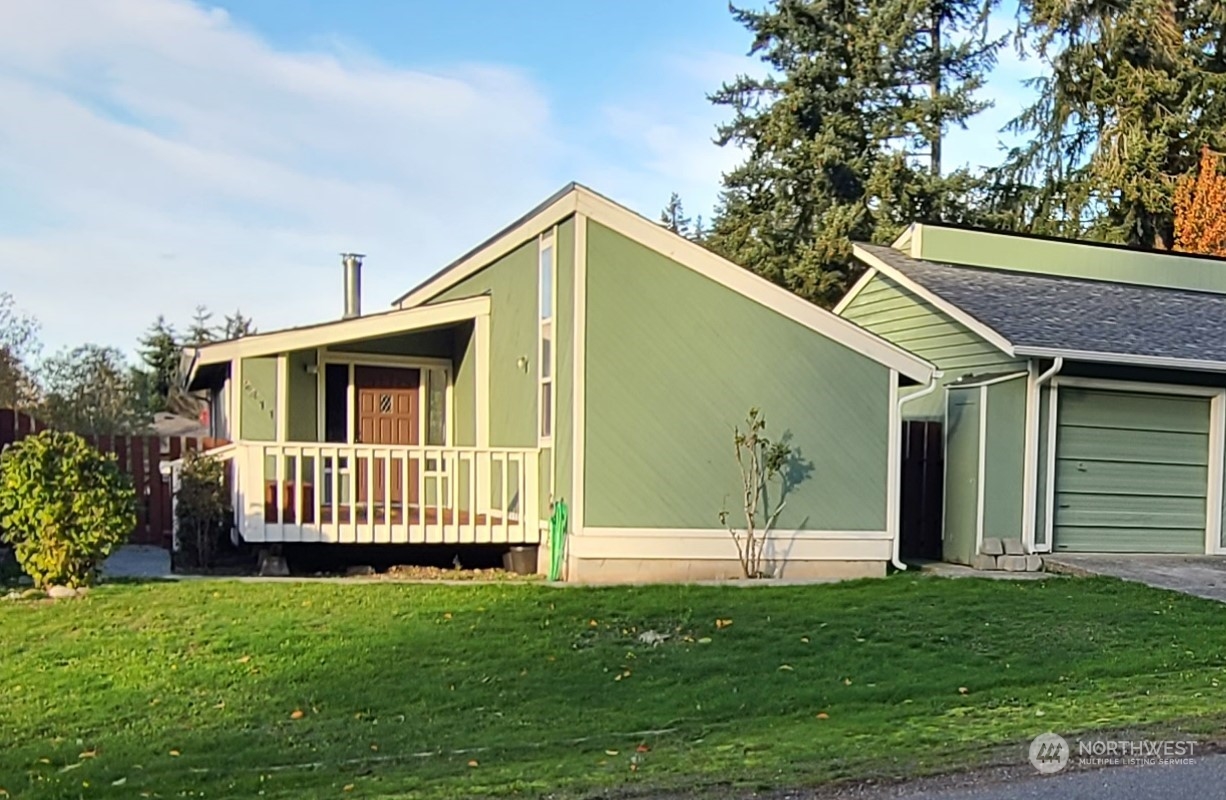 a front view of a house with a garden