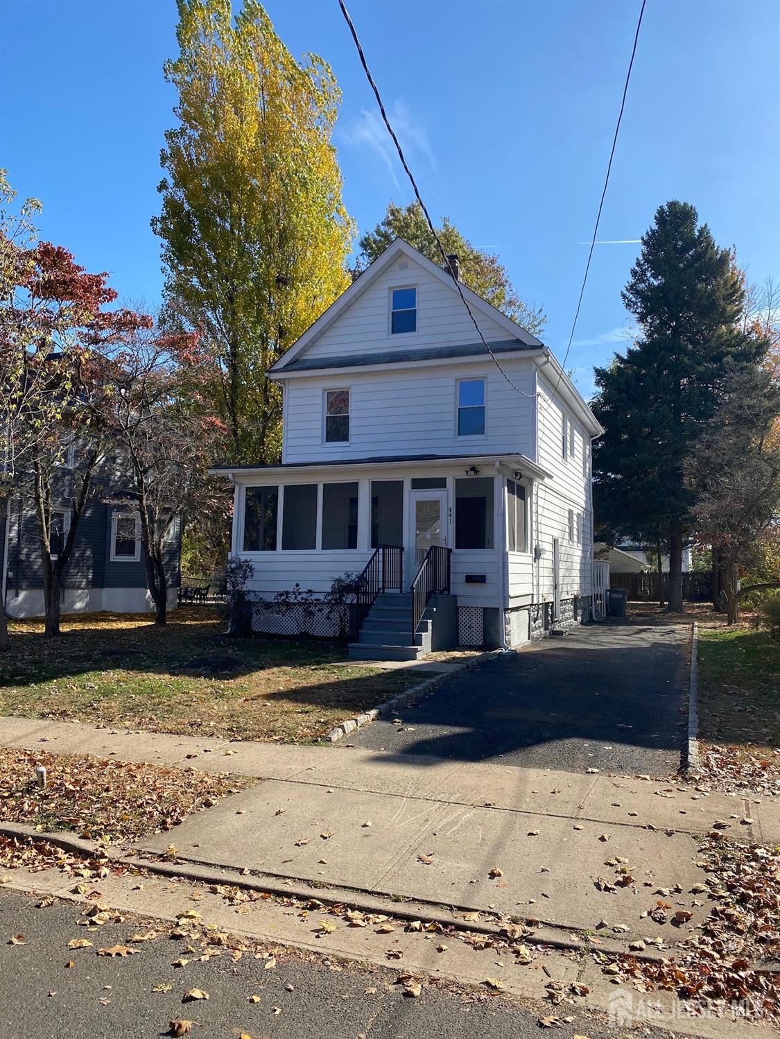 a front view of a house with a yard covered with snow