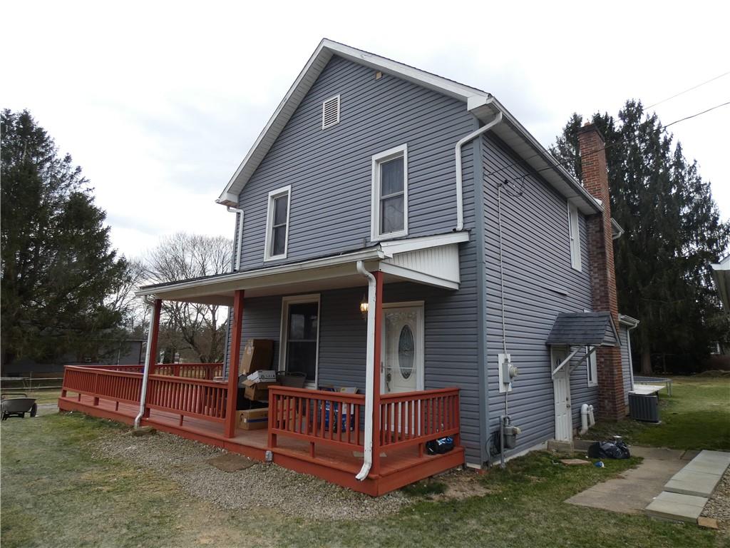 a view of a house with a yard and sitting area