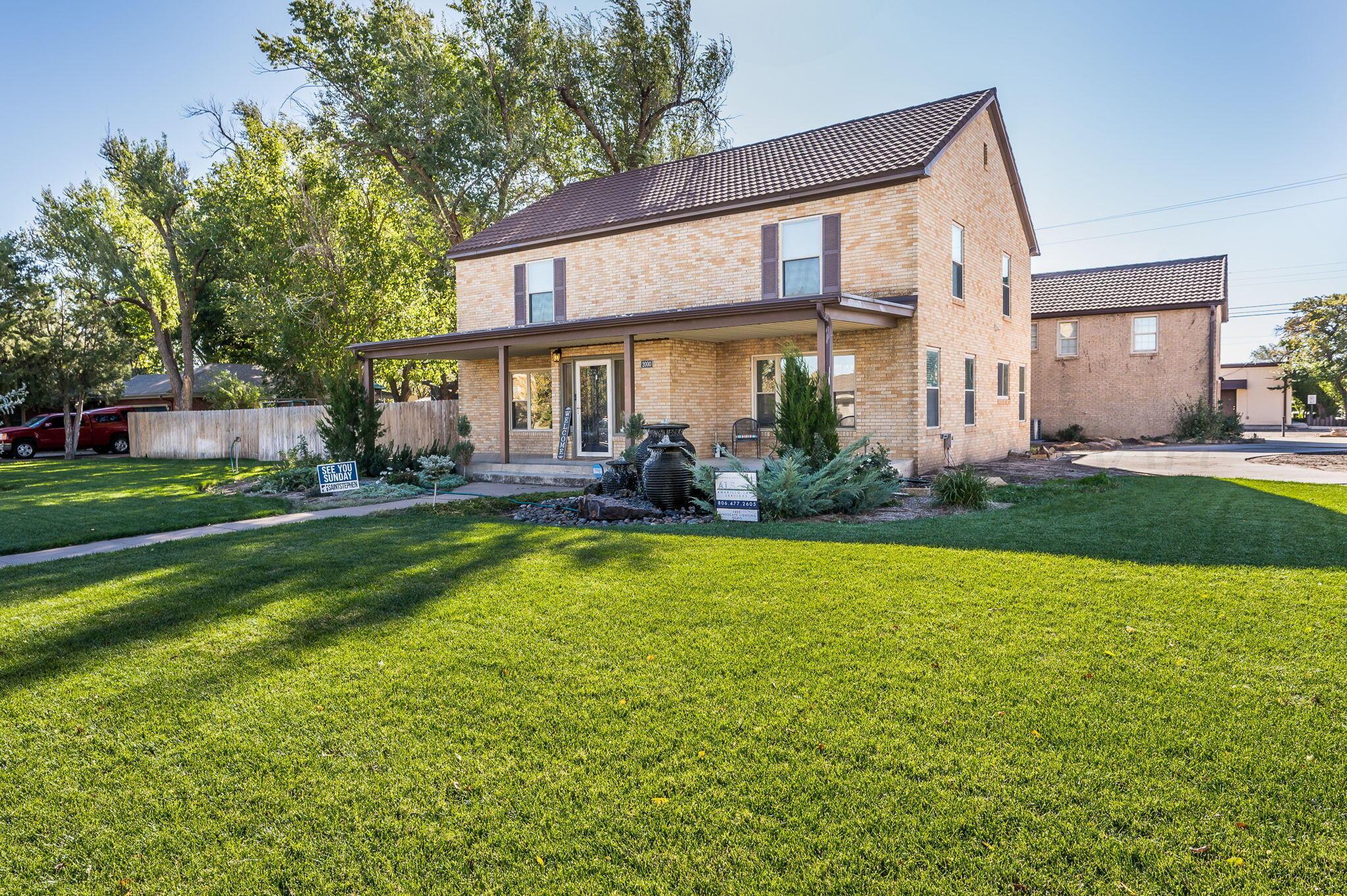 a front view of house with yard and outdoor seating