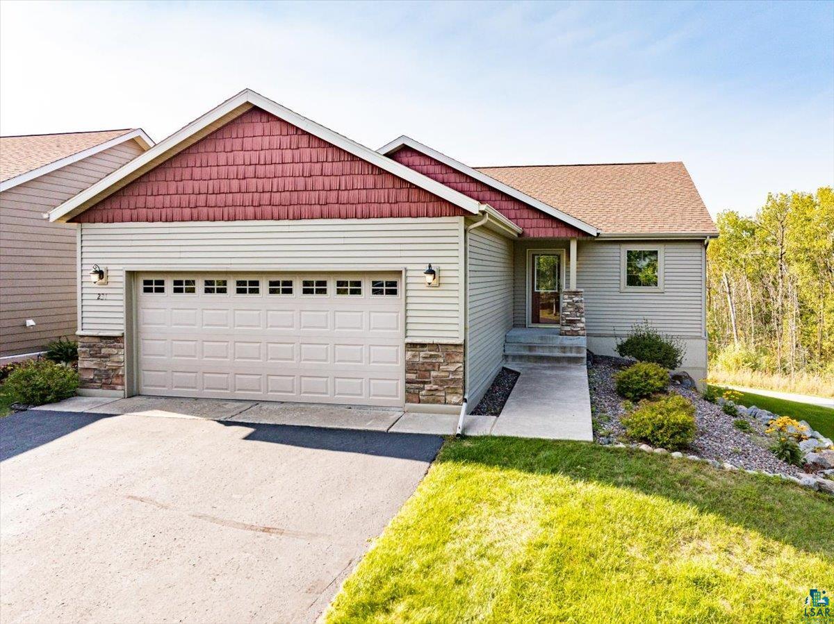 View of front of home featuring a garage and a front lawn