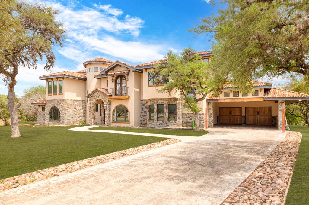 a big house with a big yard and large trees