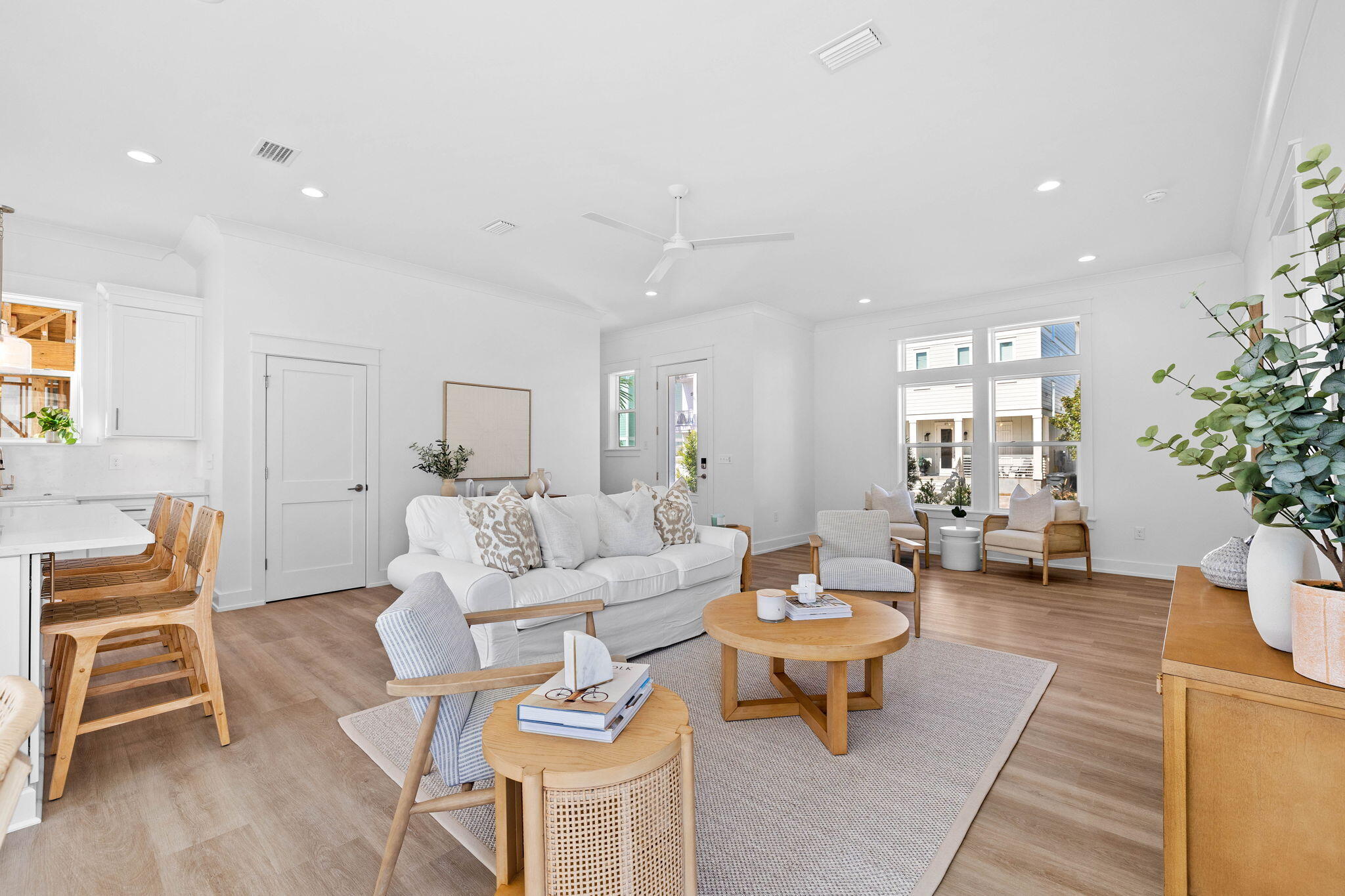 a living room with furniture a dining table and a potted plant