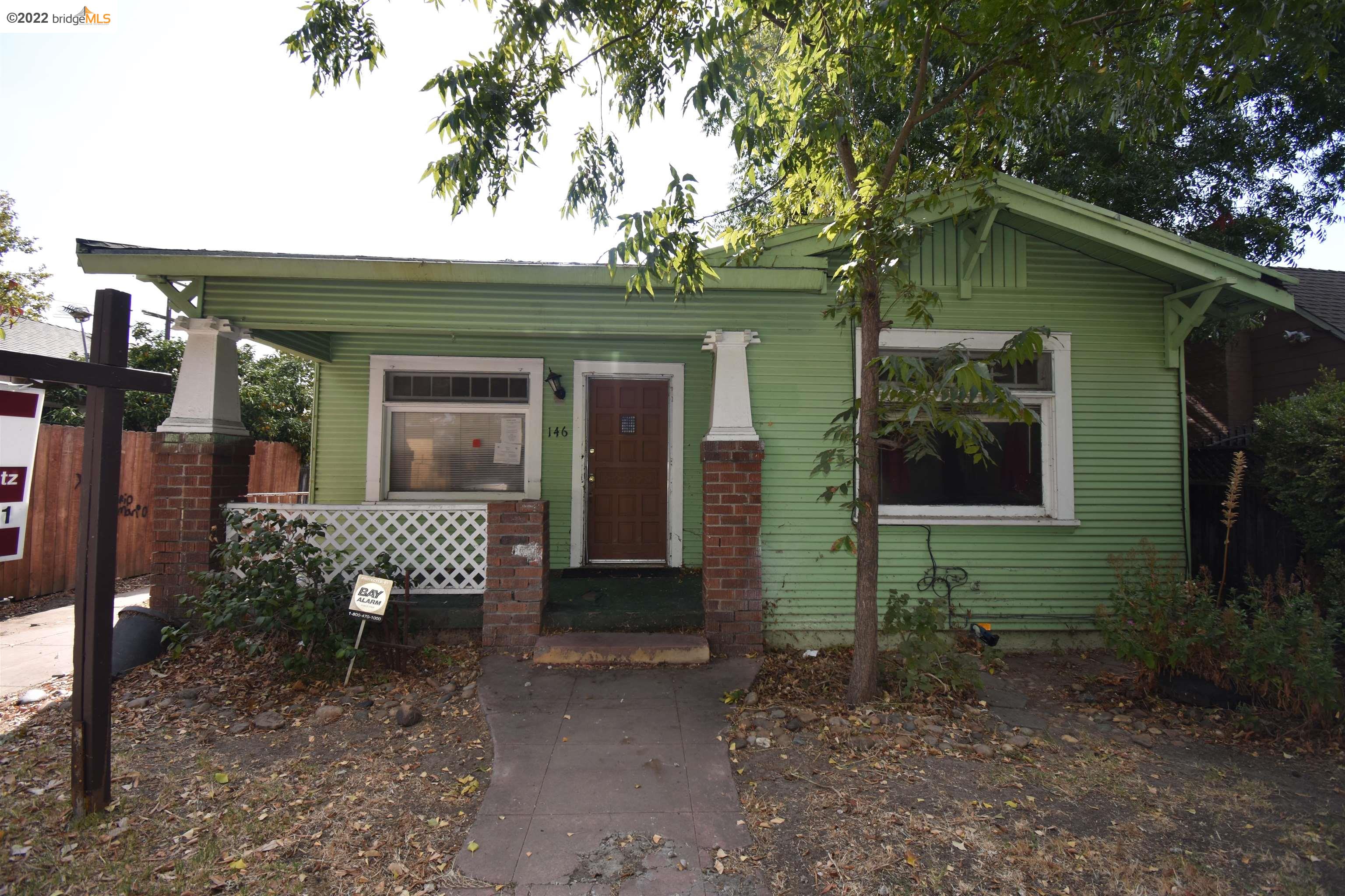 a view of a house with a yard and sitting area