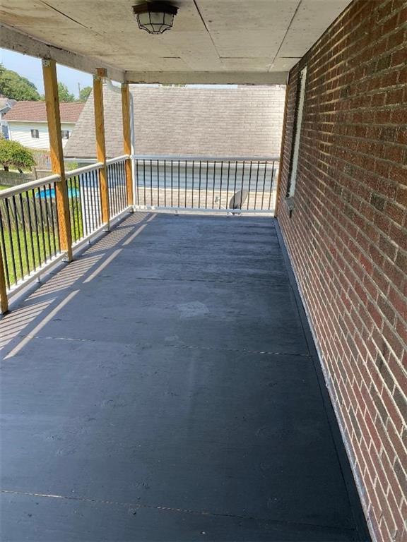 a view of porch with wooden floor