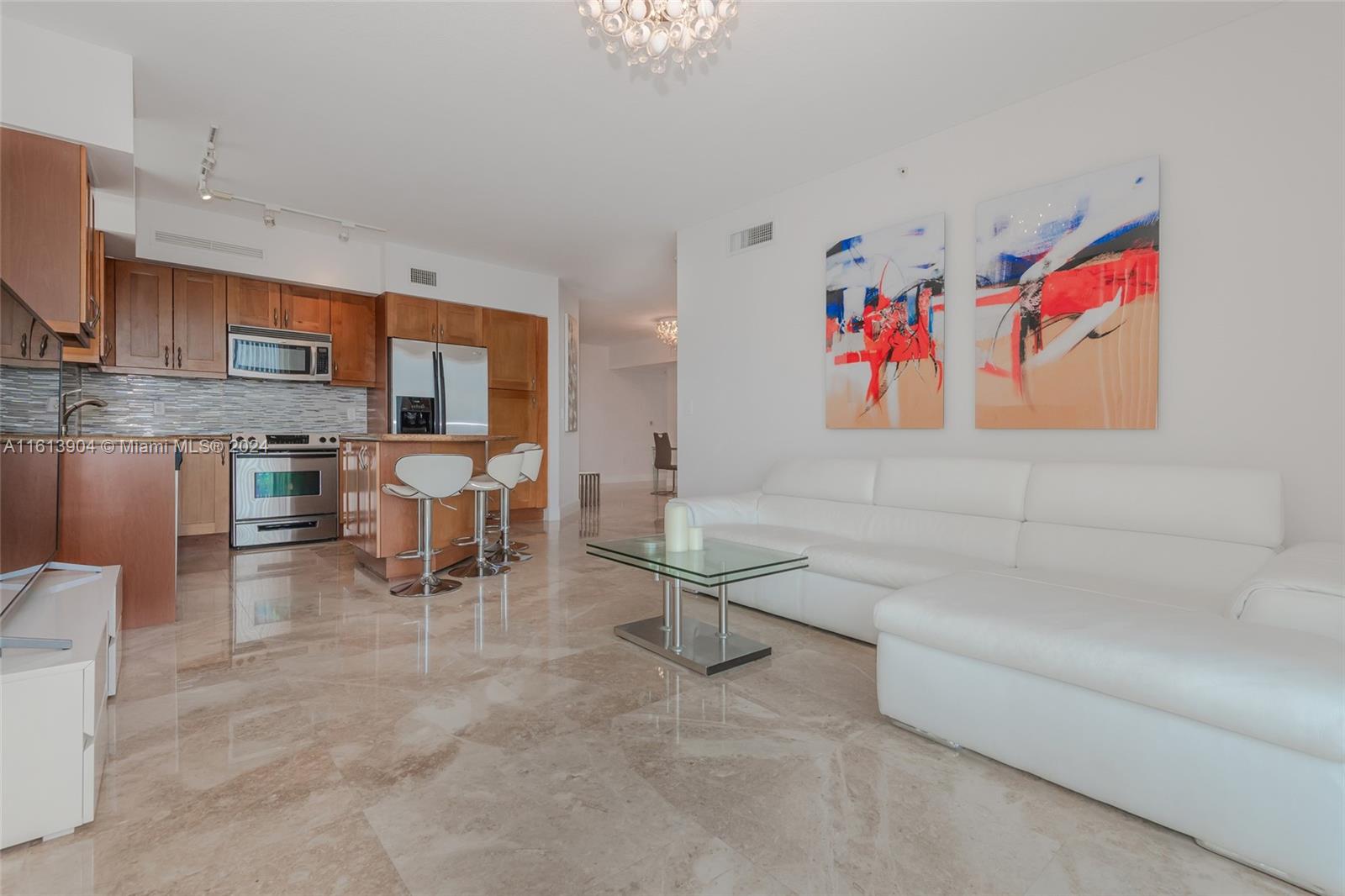 a living room with furniture a piano and a flat screen tv