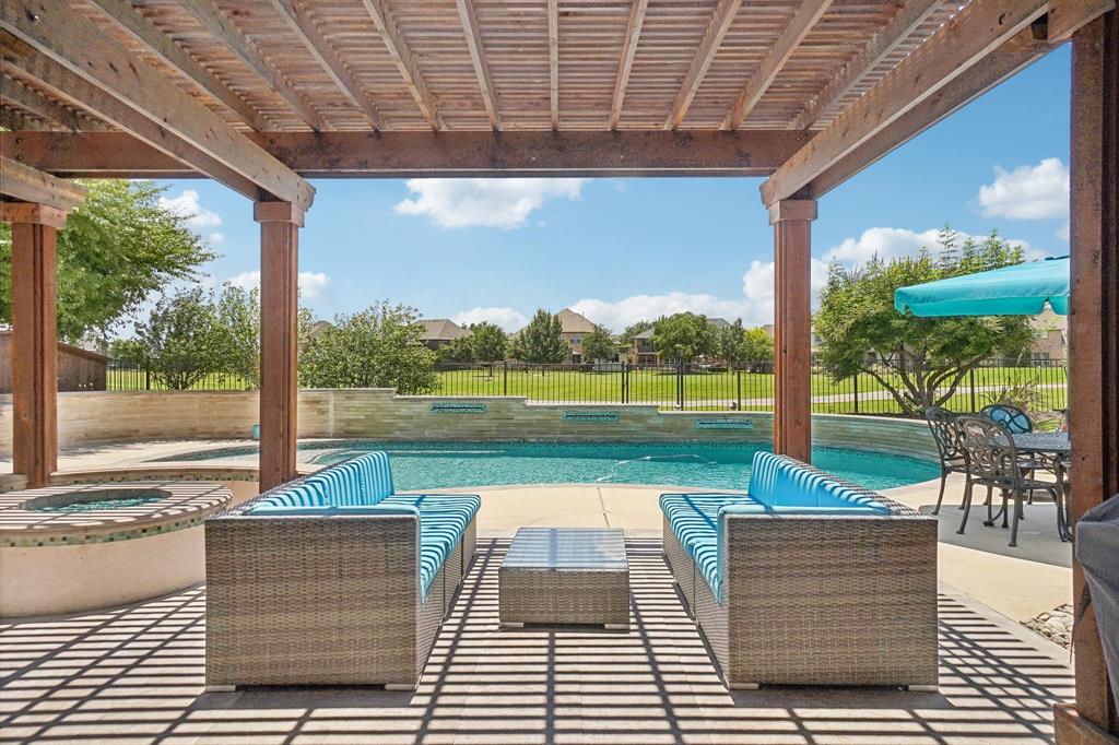 a view of a swimming pool with a porch and furniture