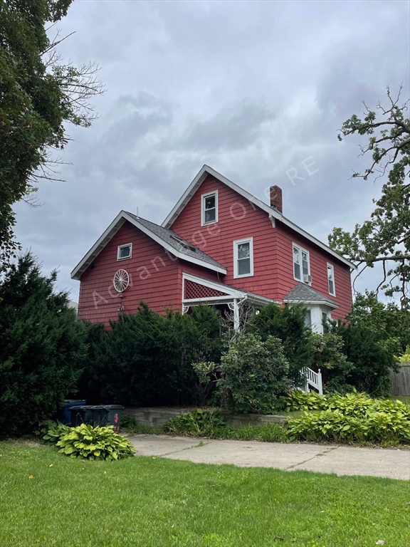 a front view of a house with a garden