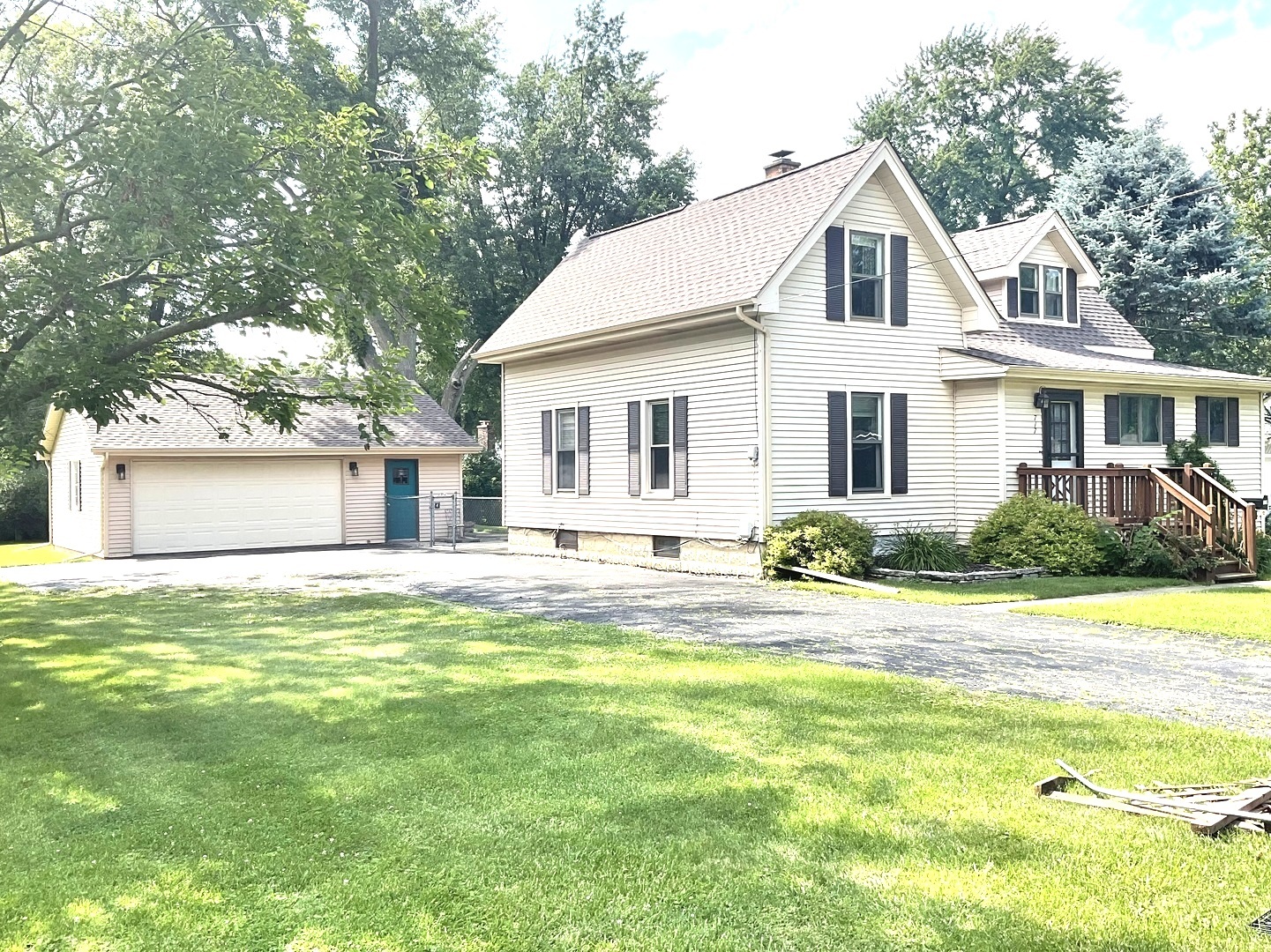 a view of a house with a yard and sitting area