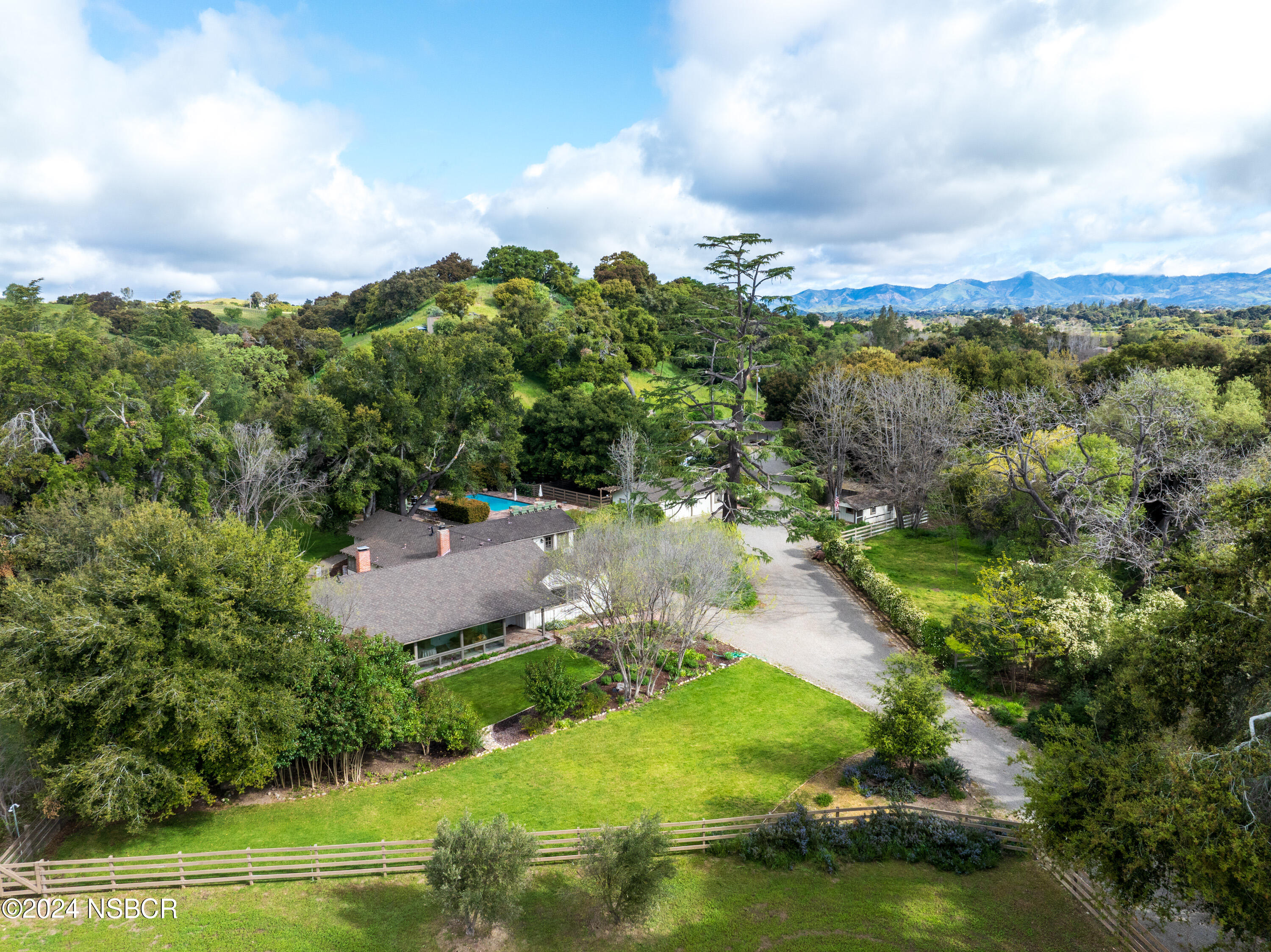 an aerial view of a house with a yard