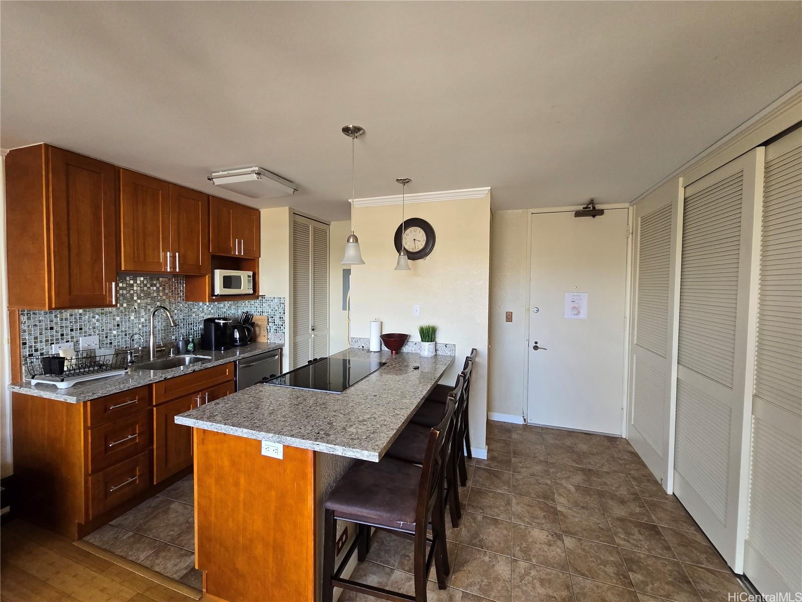 a kitchen with granite countertop a stove and cabinets