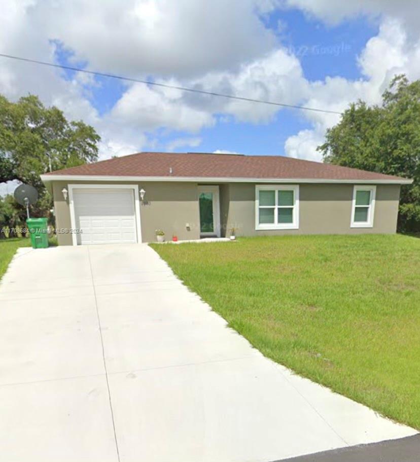 a view of house with yard outdoor seating