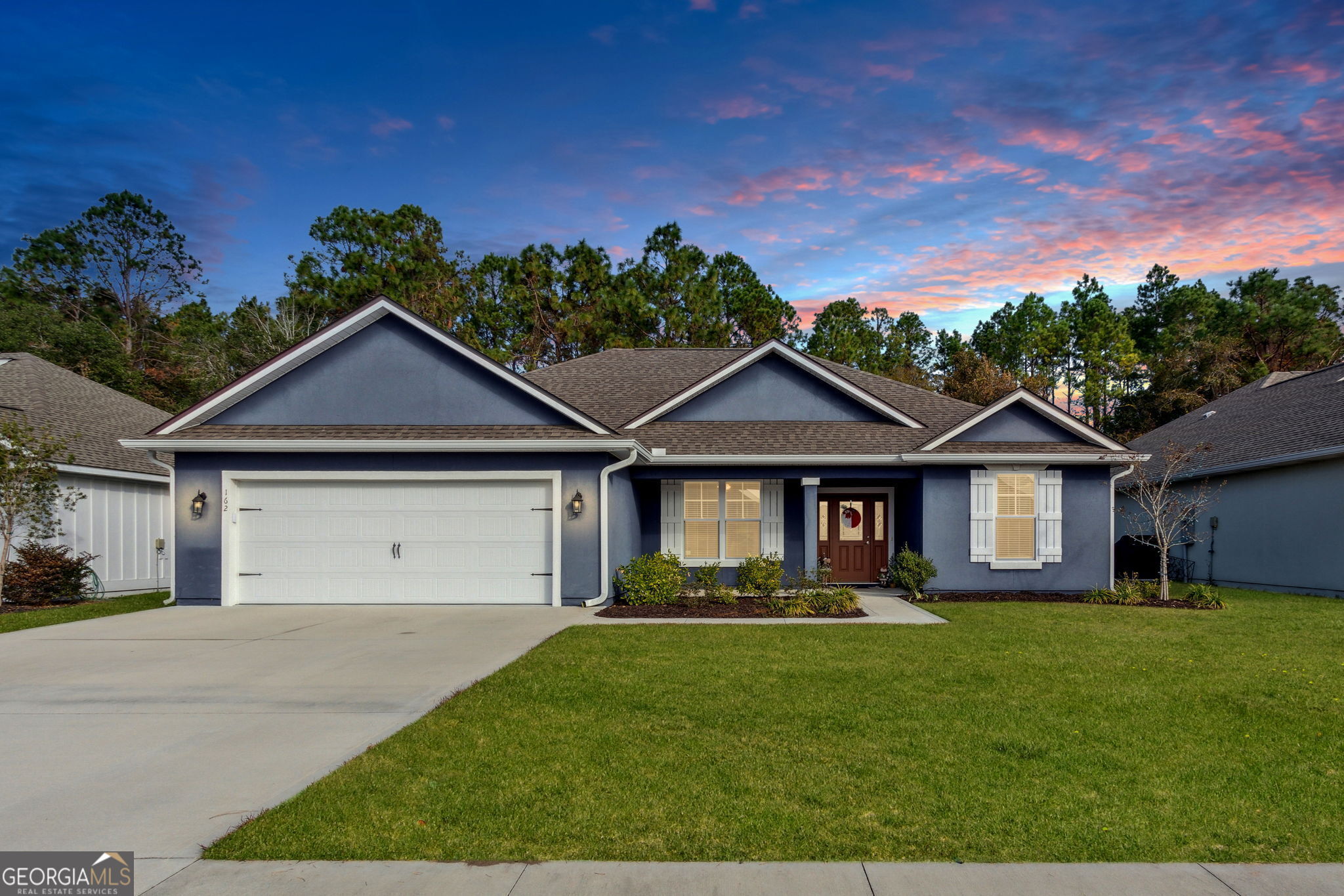 a front view of a house with a yard