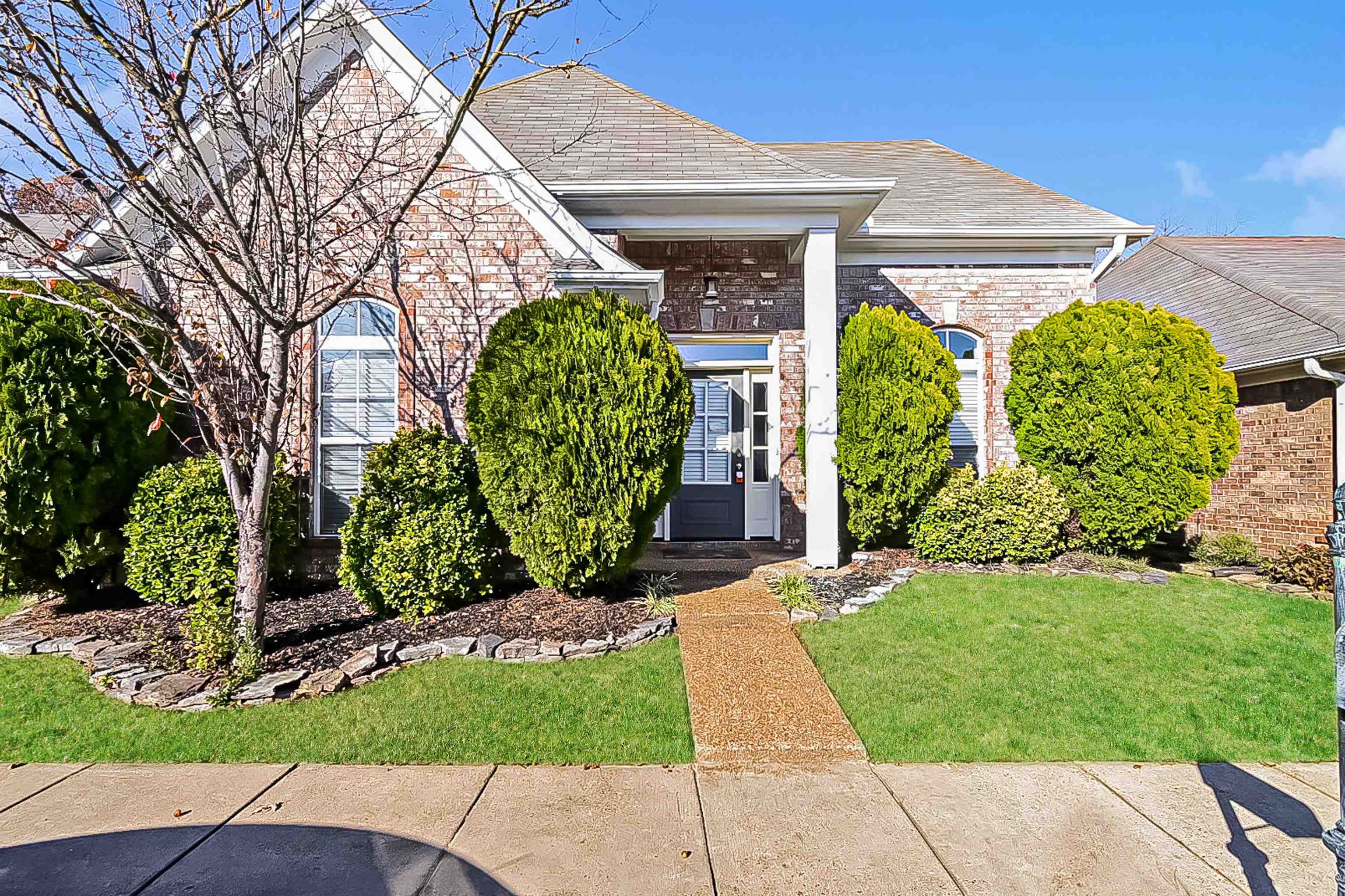 a front view of a house with garden