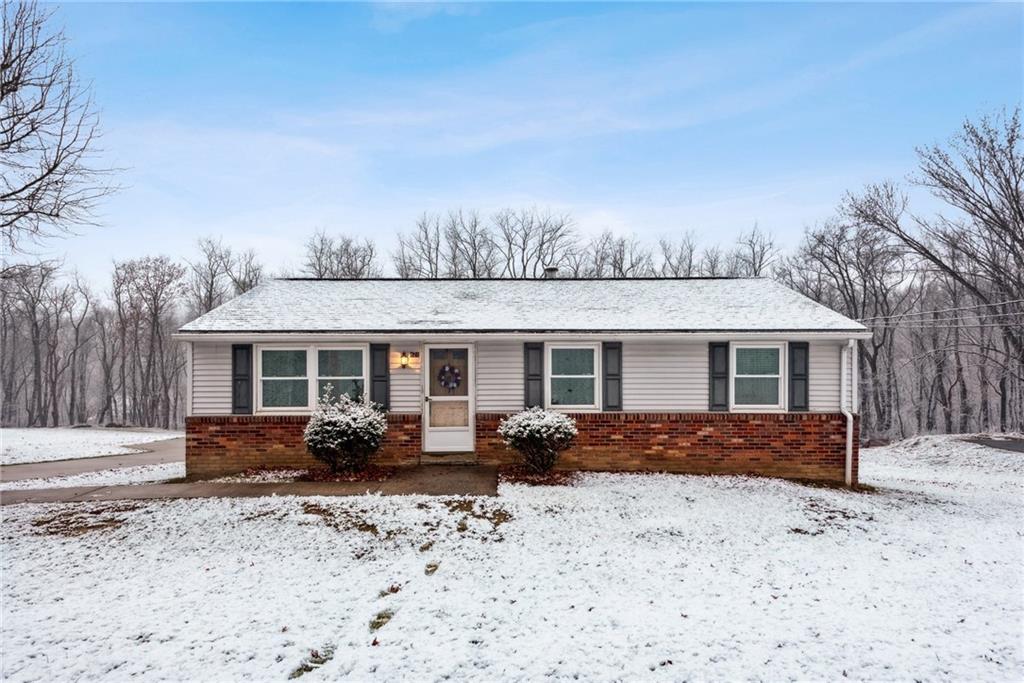 a front view of a house with yard covered in snow