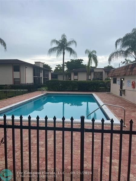 a view of swimming pool with outdoor seating and city view