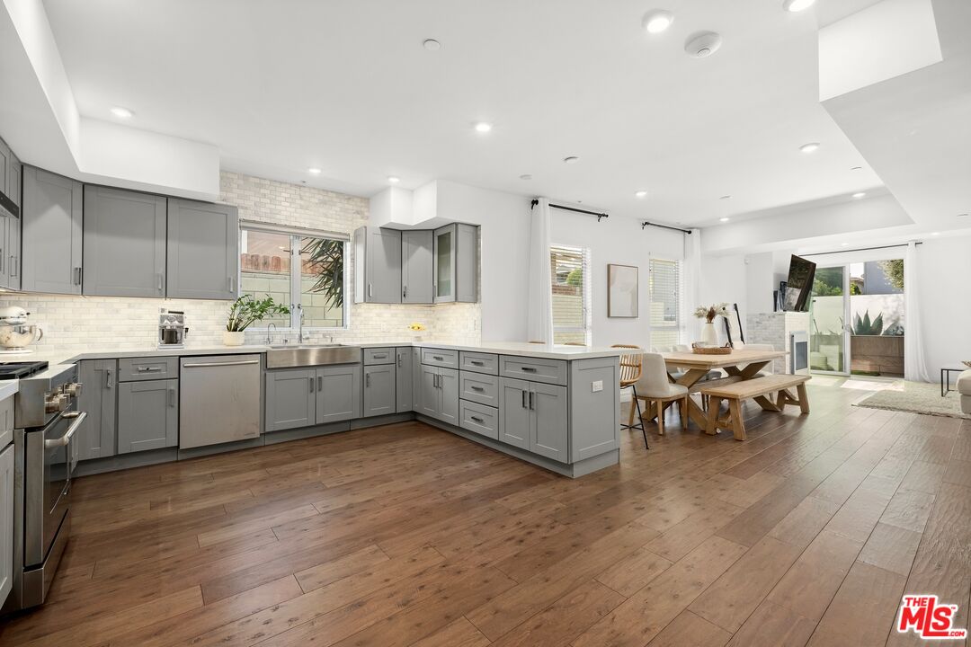 a kitchen with a sink cabinets and wooden floor