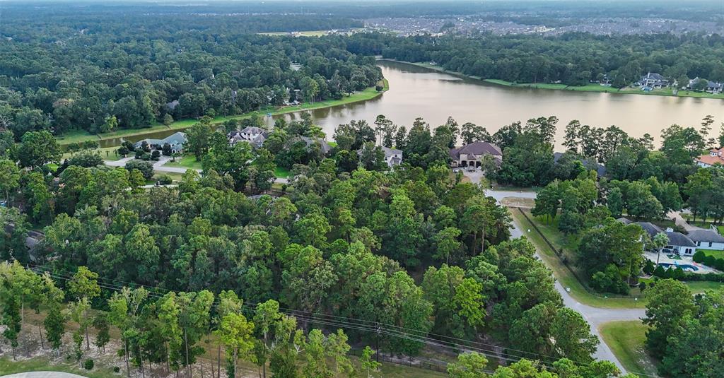 an aerial view of mountain with residential house and lake view