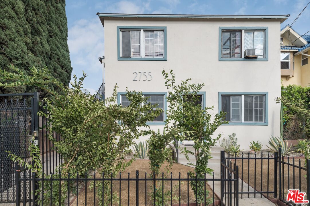 a view of a house with a tree front of house