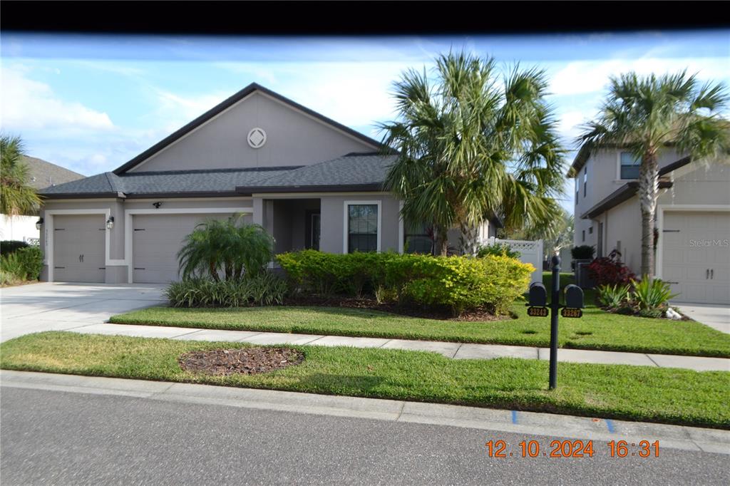 a front view of a house with a garden