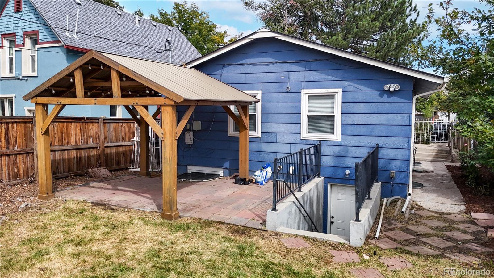 a view of a house with backyard porch and sitting area