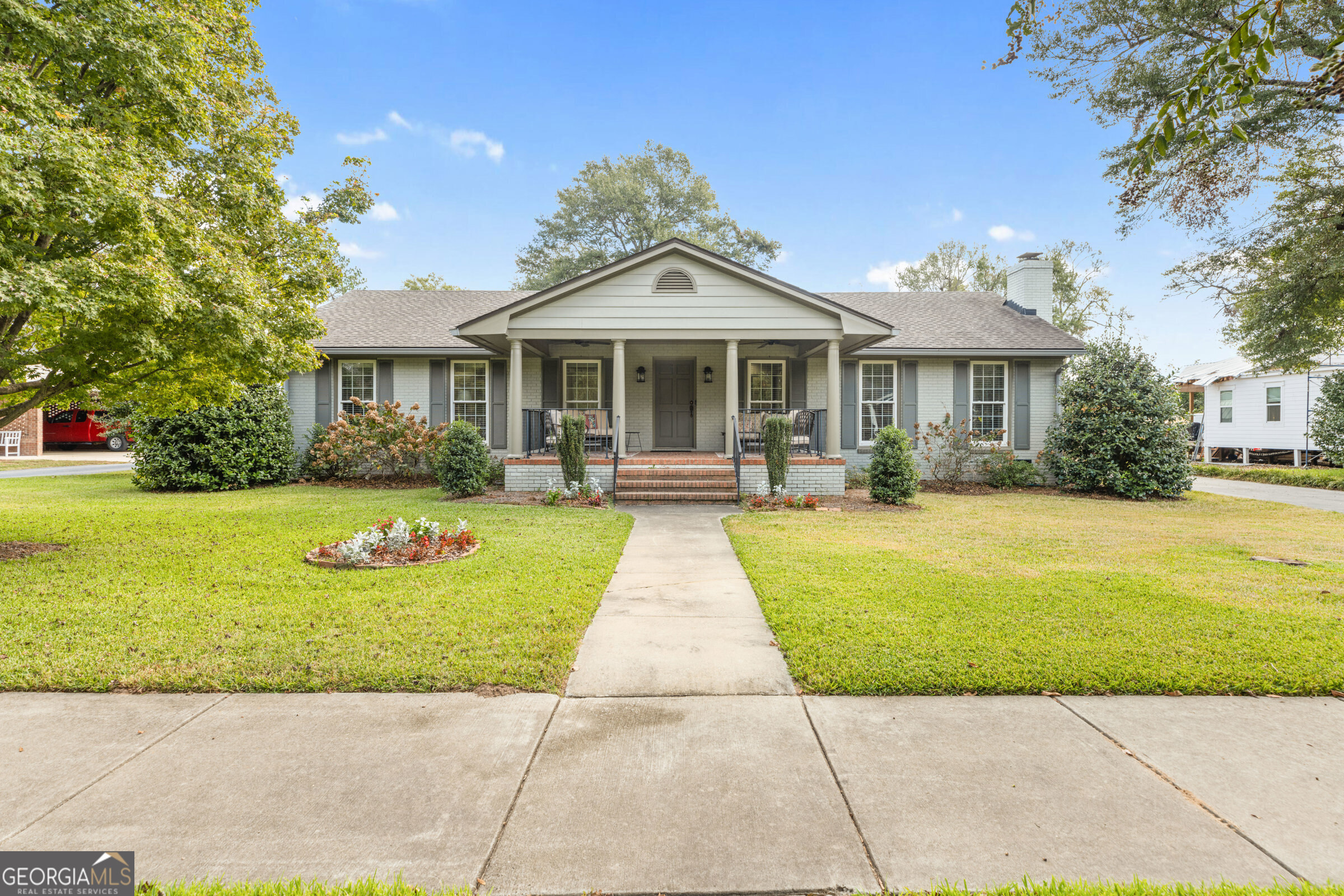 a front view of a house with garden