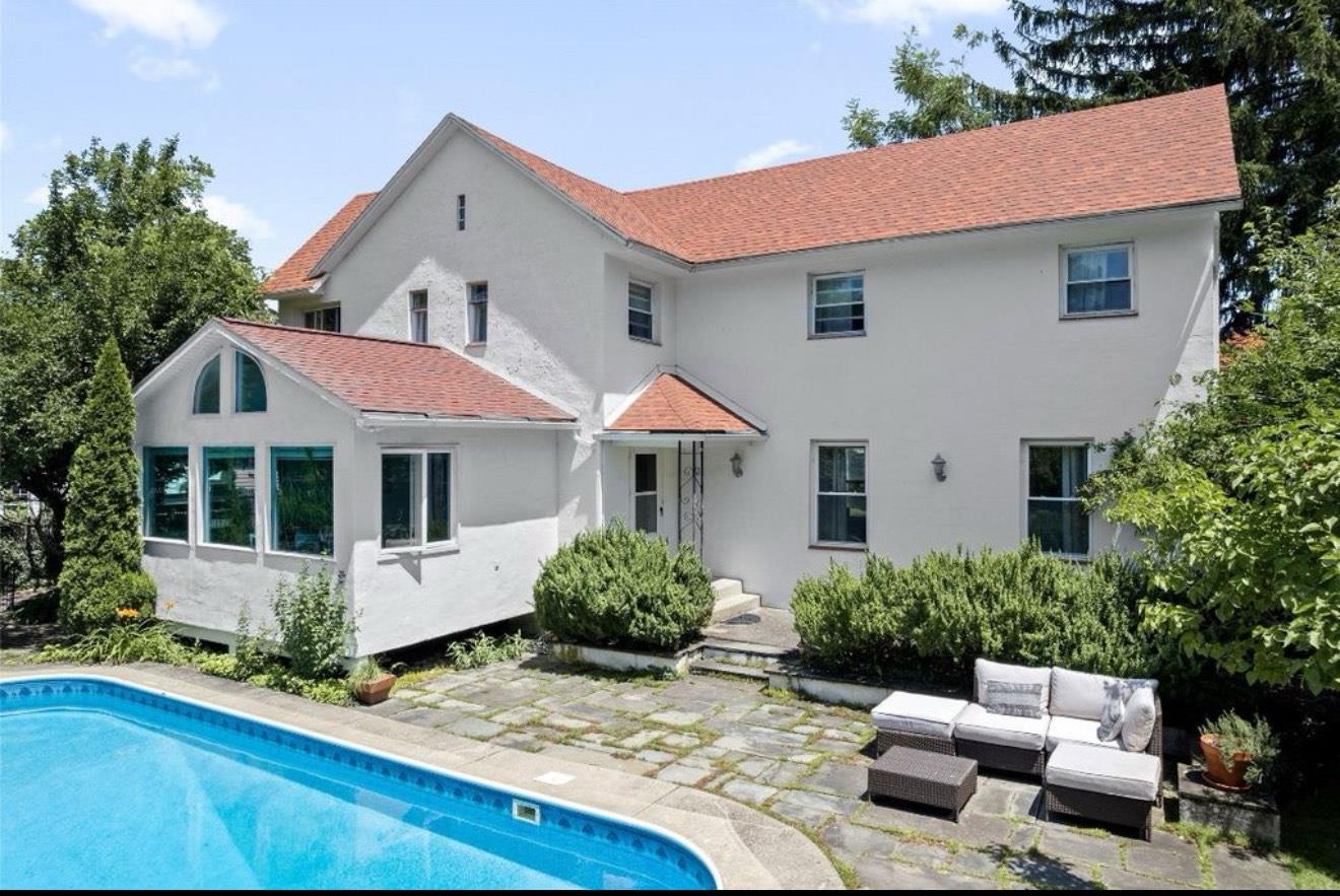 Back of house with an outdoor living space and a patio area