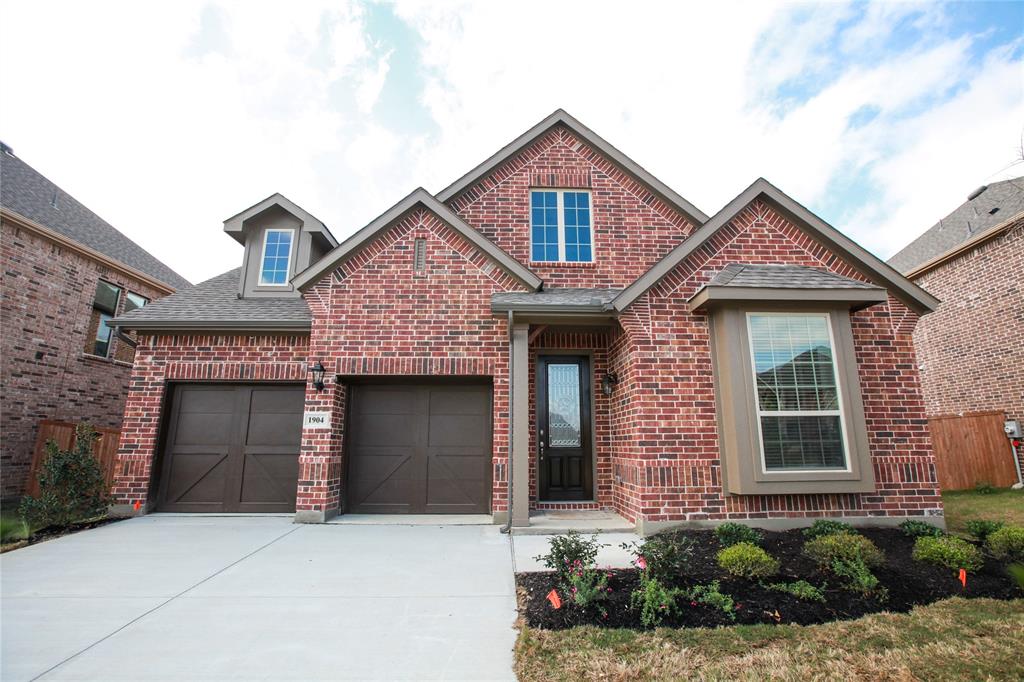 a front view of a house with garage