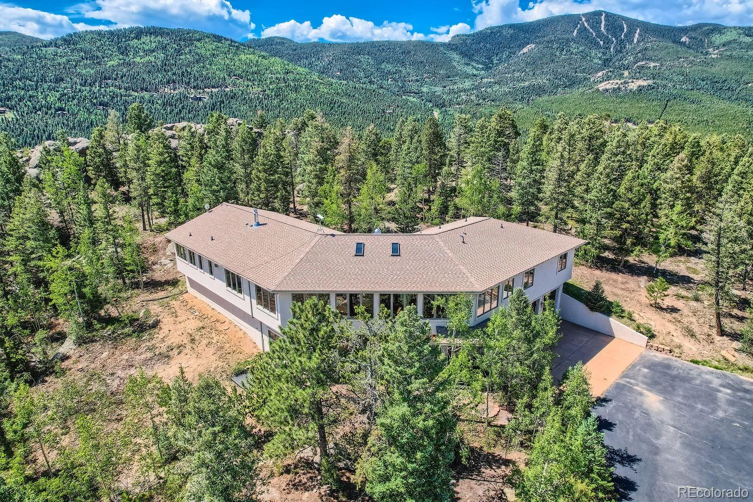 an aerial view of a house with a yard and lake view