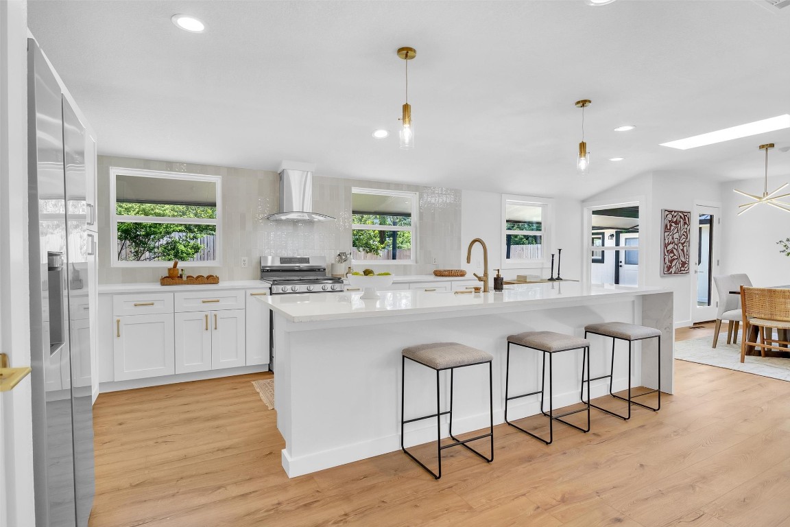 a kitchen with white cabinets and sink