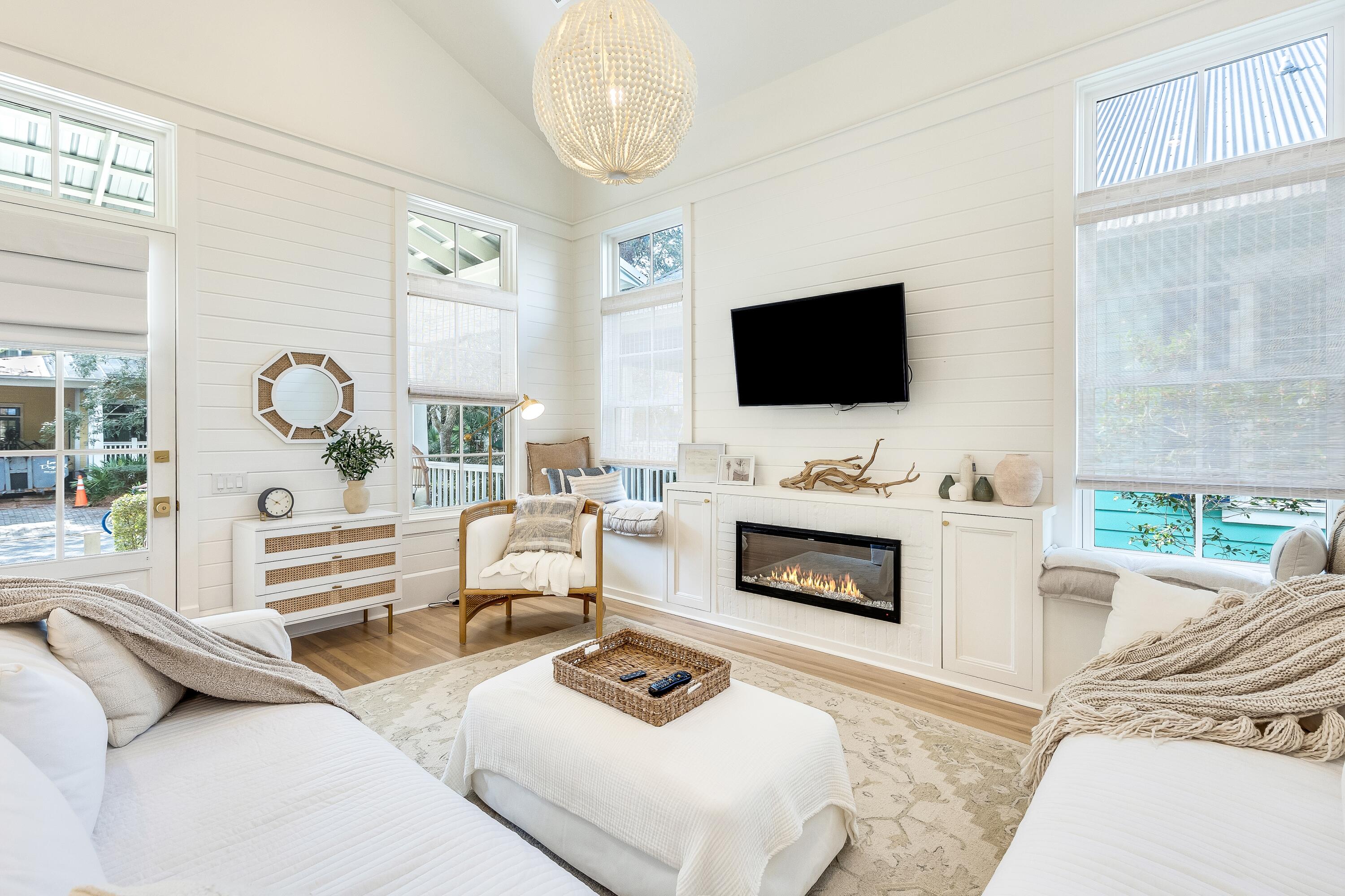 a living room with furniture a fireplace and a flat screen tv