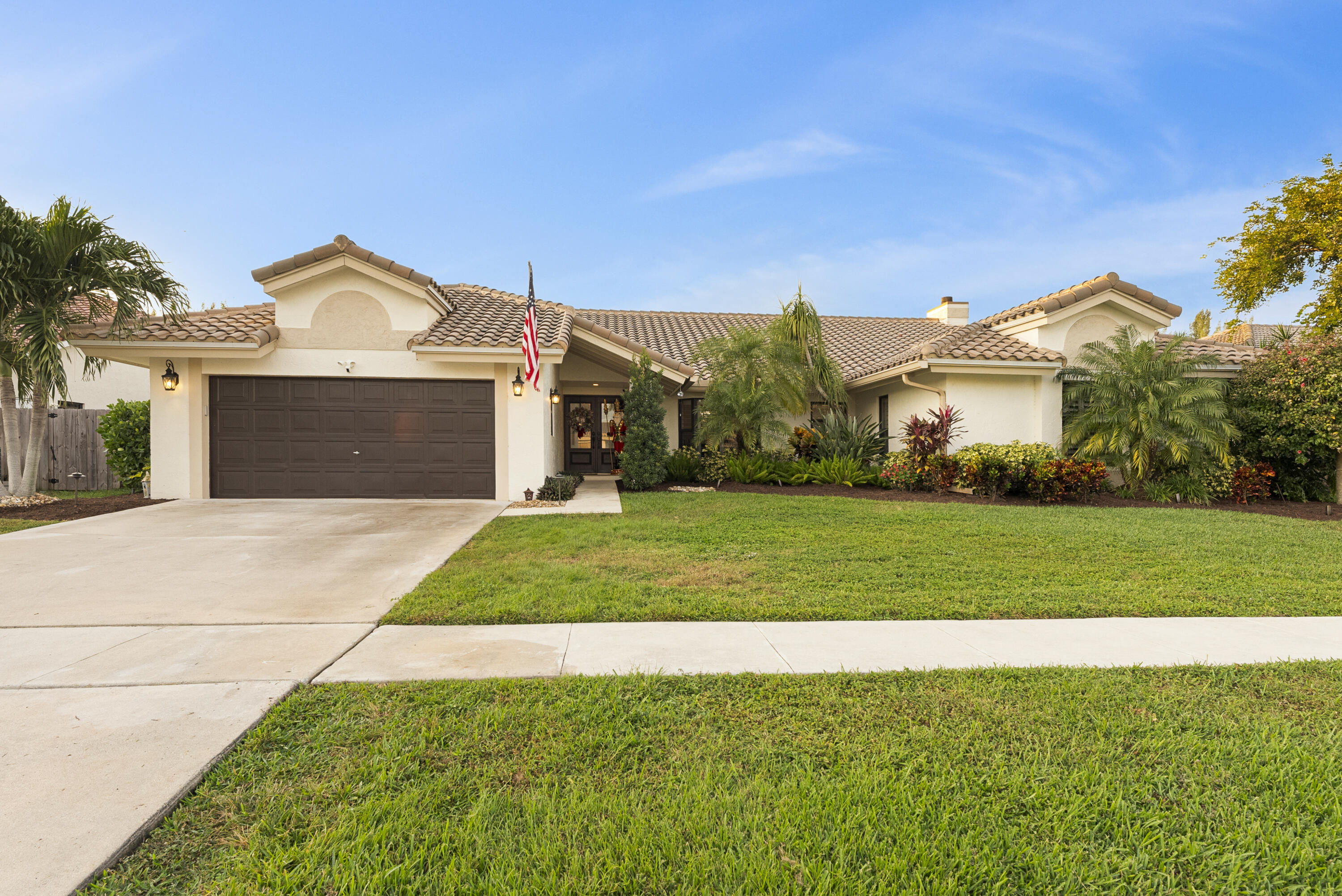 a front view of a house with a yard and trees