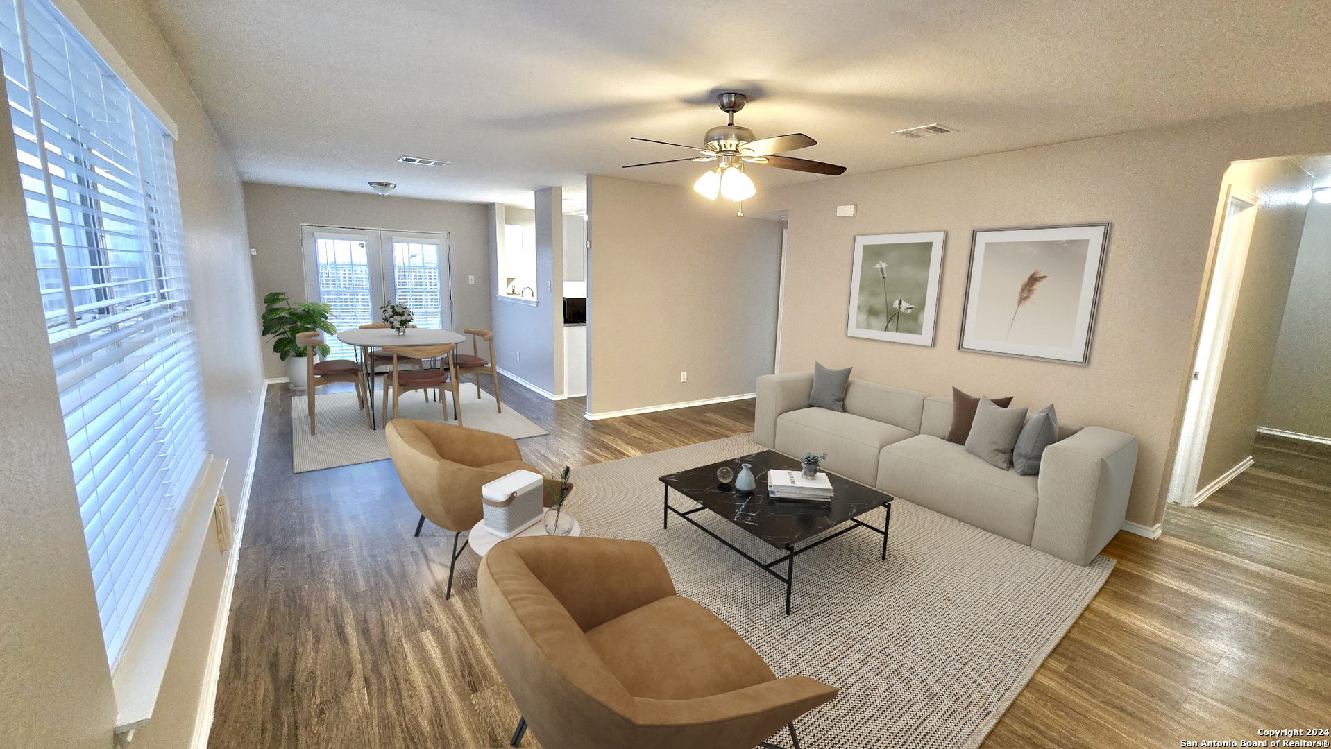 a living room with furniture and wooden floor