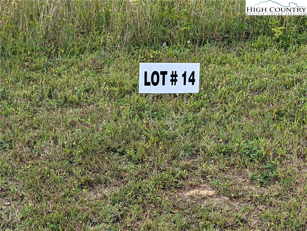 a sign broad in front of a red brick house