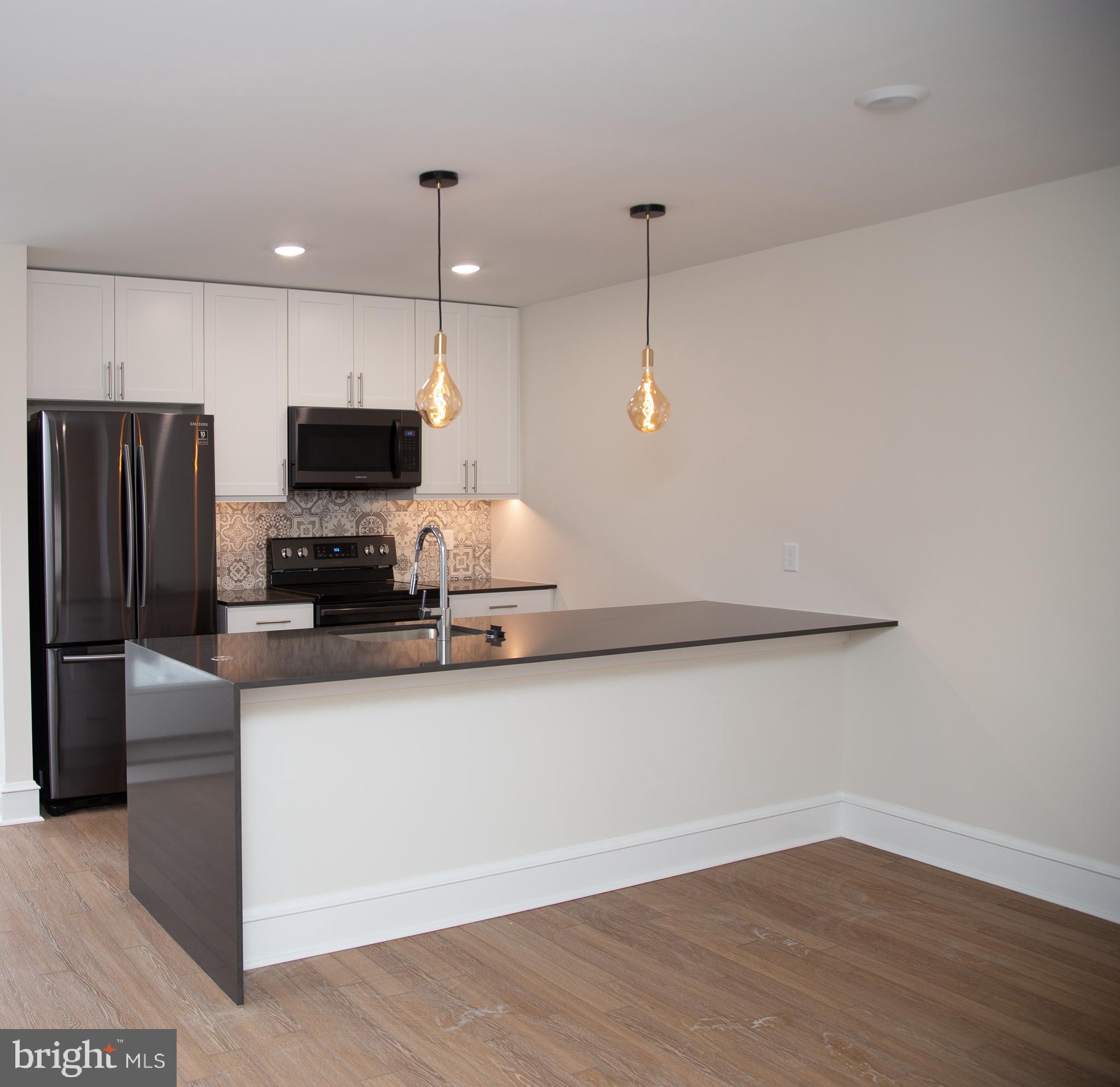 a kitchen with cabinets and stainless steel appliances