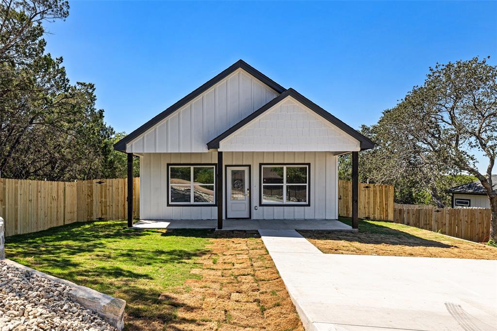 a view of a house with a backyard